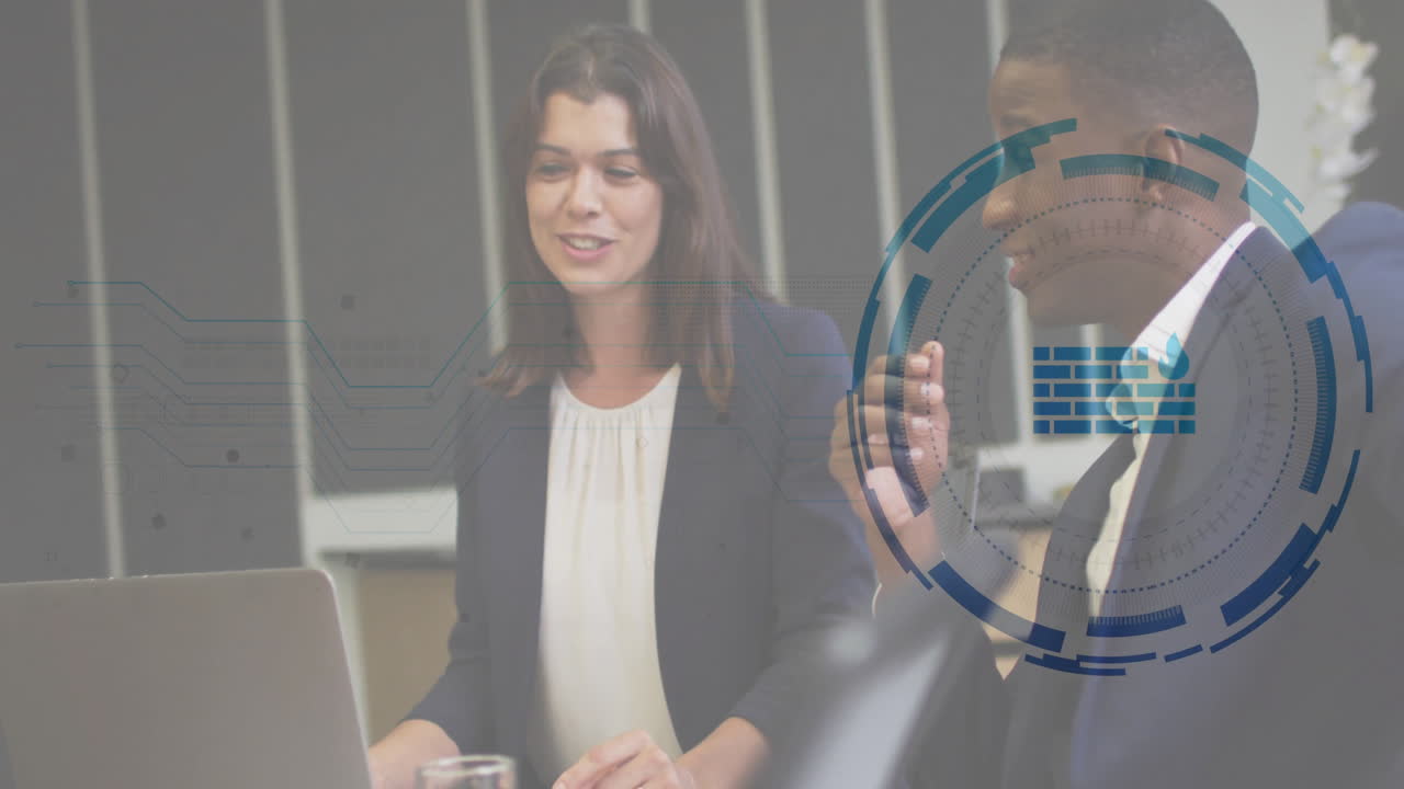 businesswoman smiling at laptop while businessman gesturing, revealing circuit graphics HUD overlay