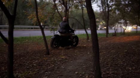 Brutal-guy-rides-a-motorcycle-cross-country-between-trees