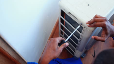 repairman fixing air conditioning