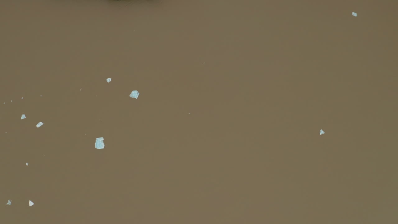 Aerial: Top down view of glacier lagoon