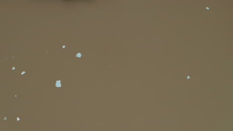 Aerial:-Top-down-view-of-glacier-lagoon