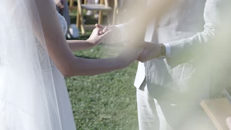 bride and groom holding hands saying wedding vows