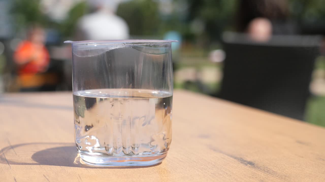 야외 카페 의 테이블 에 있는 물 한 잔