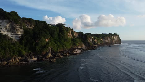 Drone-shot-following-cliffs-towards-the-point-in-Uluwatu,-Bali