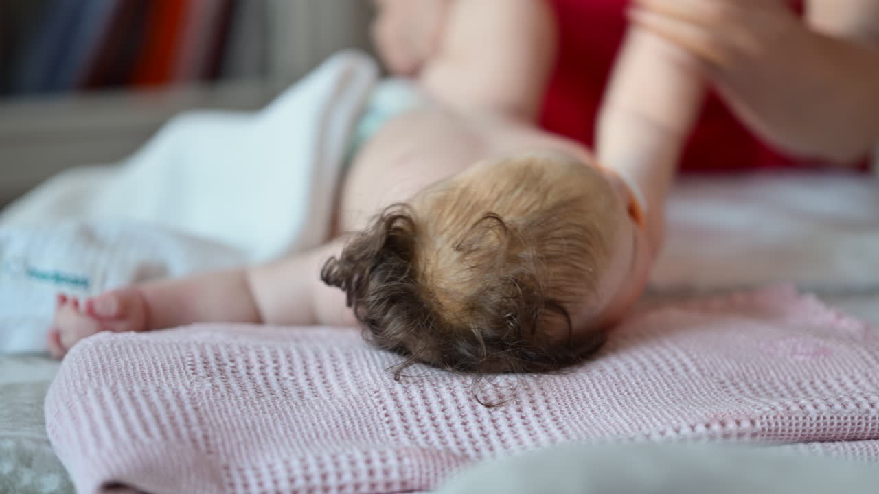 Caregiver doing mobility exercises with a baby
