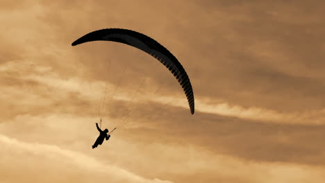 paragliding silhouette at sunset