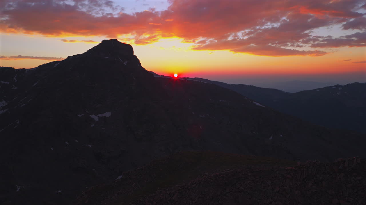 Mount of the Holy Cross Colorado 14er peak Sawatch Range aerial drone Vail Minturn Halo Ridge golden hour vibrant sunset on Rocky Mountains horizon Notch Mountain shelter pan left motion