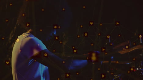 drummer performing on dimly lit studio stage with floating social media icons showing technology