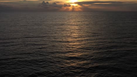 Aerial-Open-Sea-Ocean-Purple-Sunset-Multicolored-Clouds,-direct-sunlight