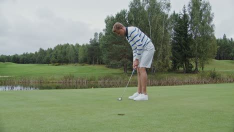 man putting on a golf course