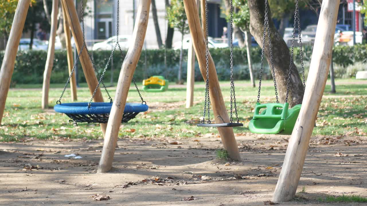Empty swings in a park on a sunny autumn day