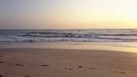 parallel movement viewing waves crashing on beach during sunset