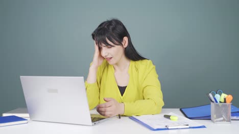 woman looking at laptop gets frustrated.