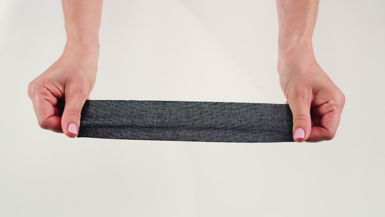 Kinesiology medical taping, doctor Physical therapist applying elastic surgical tape to patient body, treating injured knee young athlete.Post traumatic rehabilitation, sport physical therapy recovery