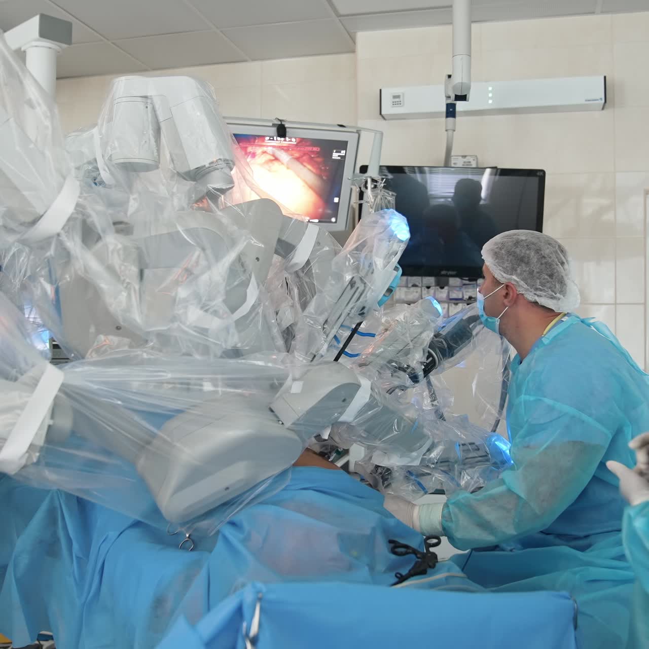 Surgeons operating with surgical tools. Surgeons operating under bright light in operating room