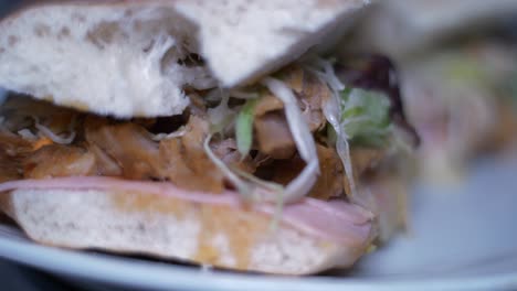 close-up view of a delicious sandwich with meat, cabbage, and lettuce
