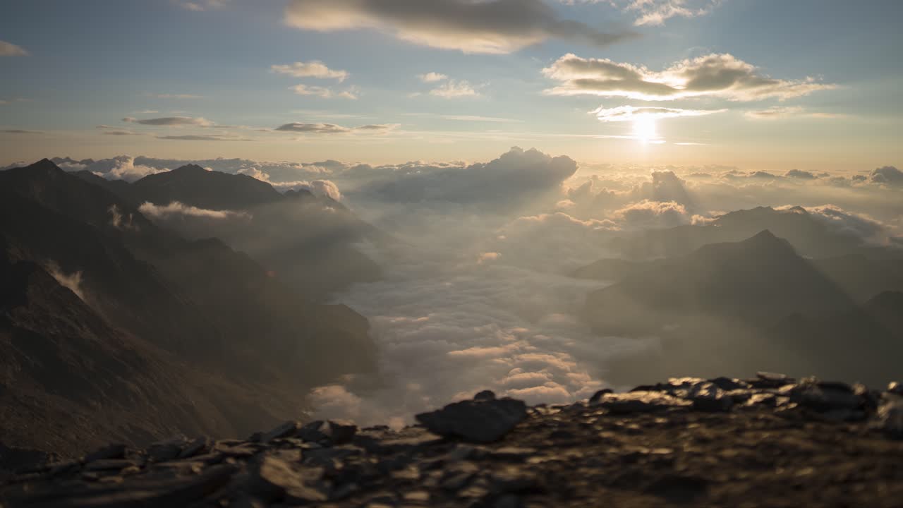 Timelapse on a slider of a sunrise in the Italian Alps with lots of clouds in the valley