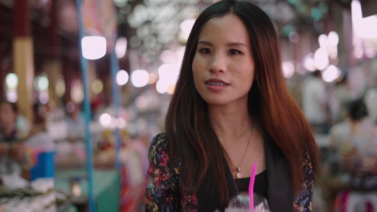 Young Woman Browsing a Bustling Indoor Market