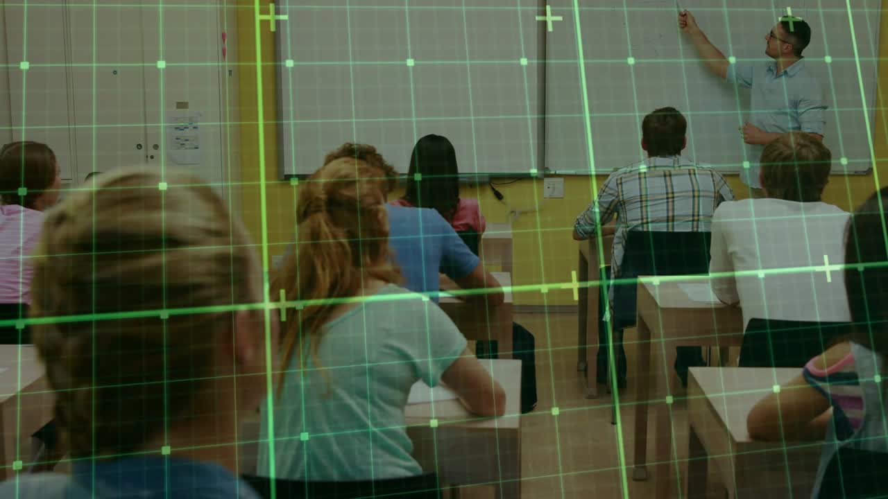 Teacher writing in class while student raising hand for help, teacher glancing, green grid scanning