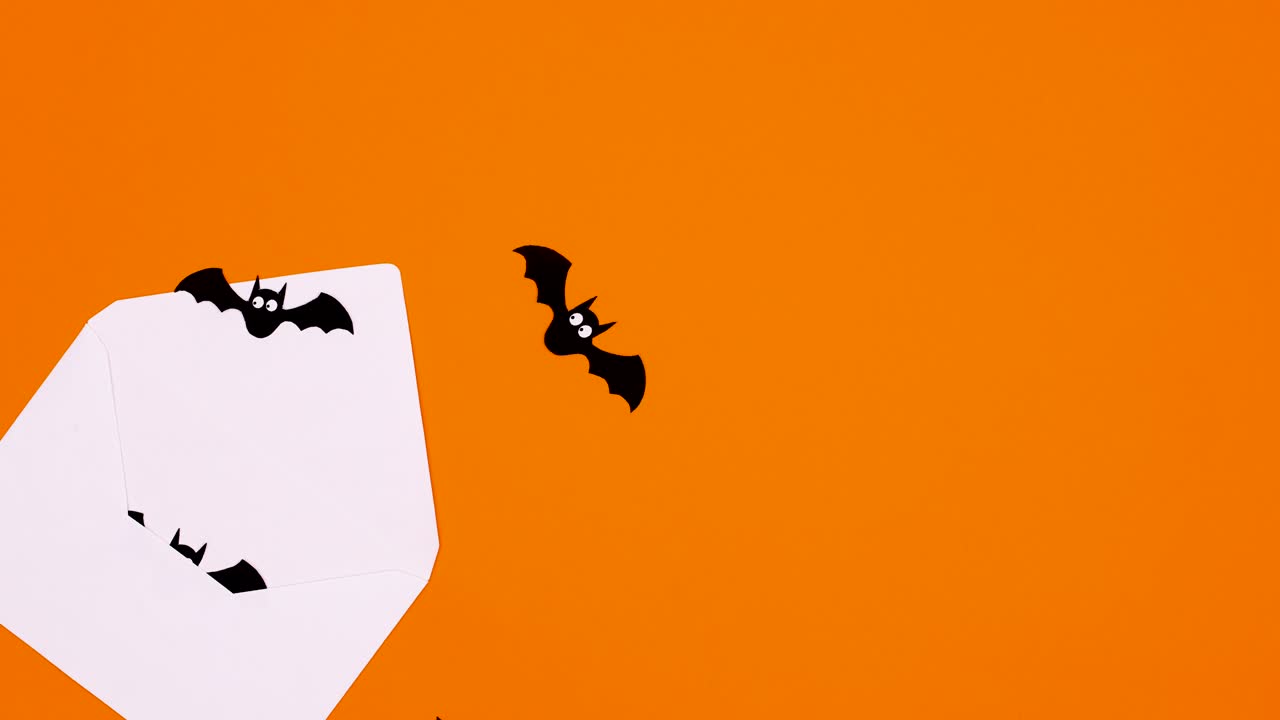 los murciélagos de halloween salen volando del sobre con el tema naranja.