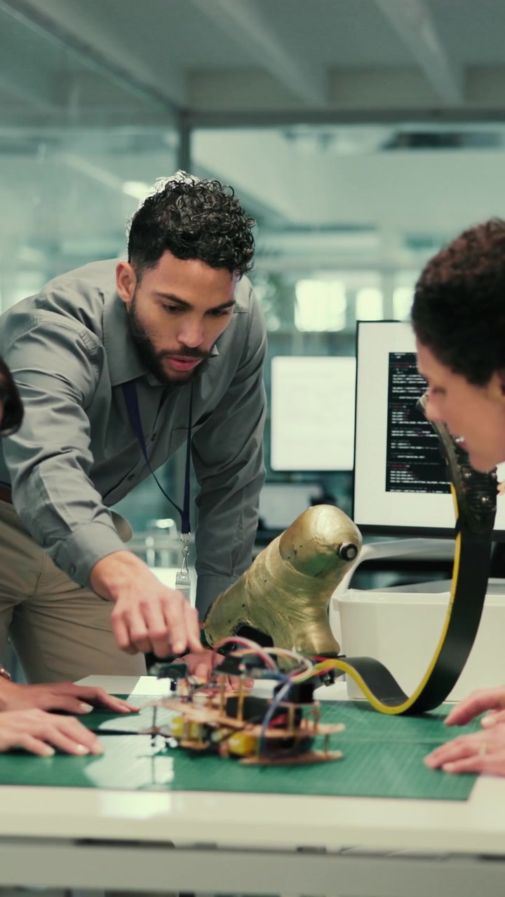 Engineers Collaborating on Robotic Prototype in Modern Laboratory