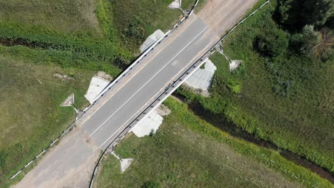 aerial view of a rural road bridge over a stream