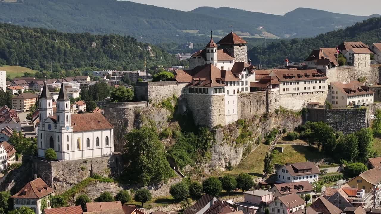 Aarburg castle in Switzerland, stunning close-up aerial view, rocky cliff with church and historic town views