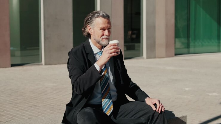 Businessman Enjoying Coffee Break Outside Office