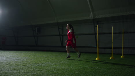young girl soccer player practicing indoor