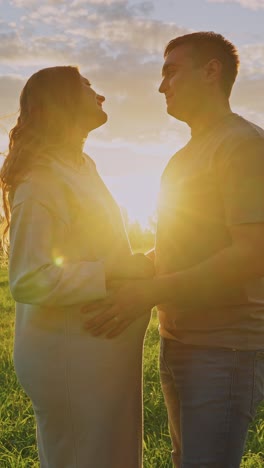 pregnant couple at sunset