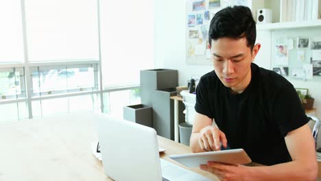 business executive using laptop and digital tablet