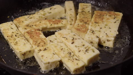 Hot-butter-sizzles-as-herb-cheese-fingers-fry-golden-in-cast-iron-pan