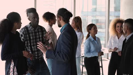happy friendly mixed race business people communicating in small groups.
