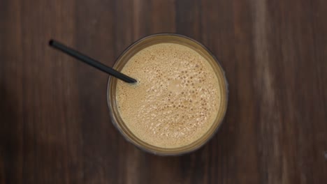 sped-up shot of frappe bubbles popping in the froth