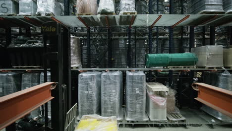 fork lift operator loading stock in a industrial distribution warehouse