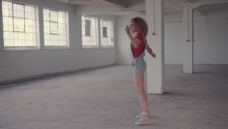 fashionable young woman in an abandoned warehouse