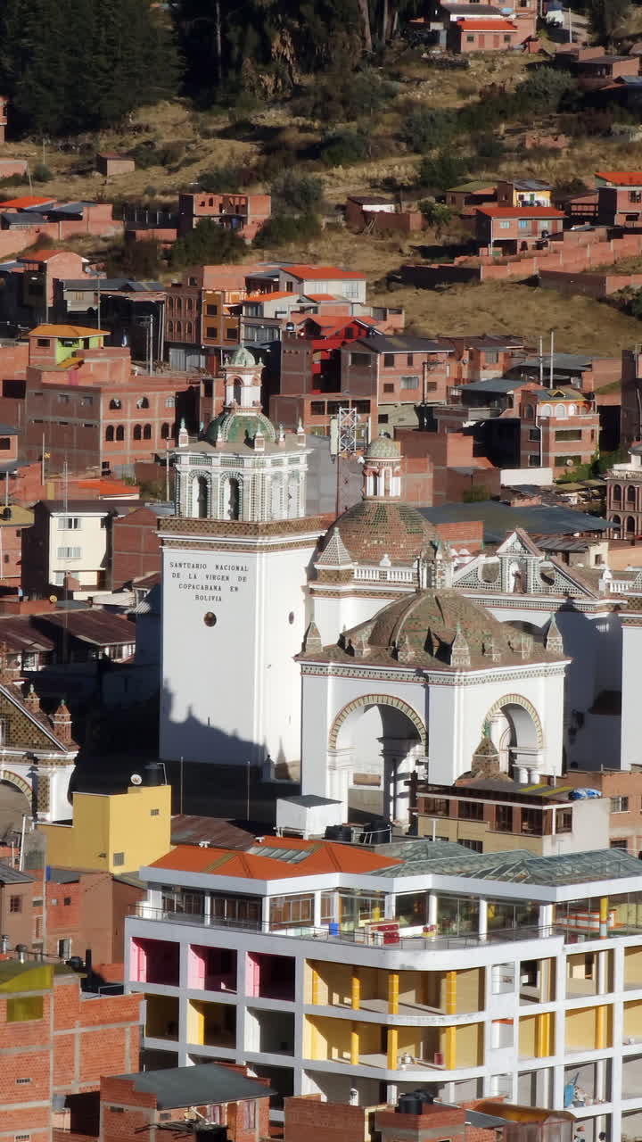 Experience a stunning aerial view of Copacabana, Bolivia, focusing on the majestic Basilica of Our Lady of Copacabana