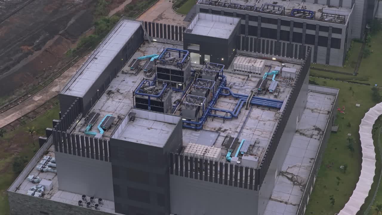 Modern industrial data center building with a complex cooling system on the roof. Aerial view of a technology and telecommunication hub in jakarta