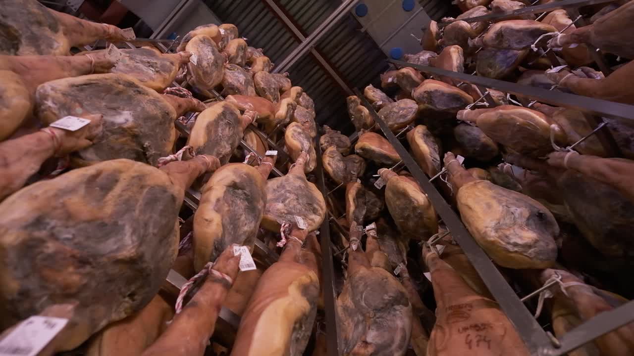 Jamon serrano pig legs factory hanging in a industry. Iberian ham elaboration process