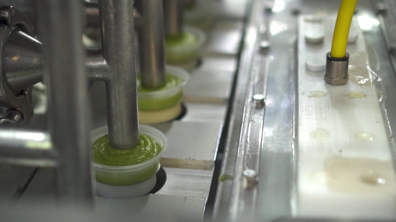 SLOW MOTION : GUACAMOLE PROCESSING PLANT DETAIL SHOT
