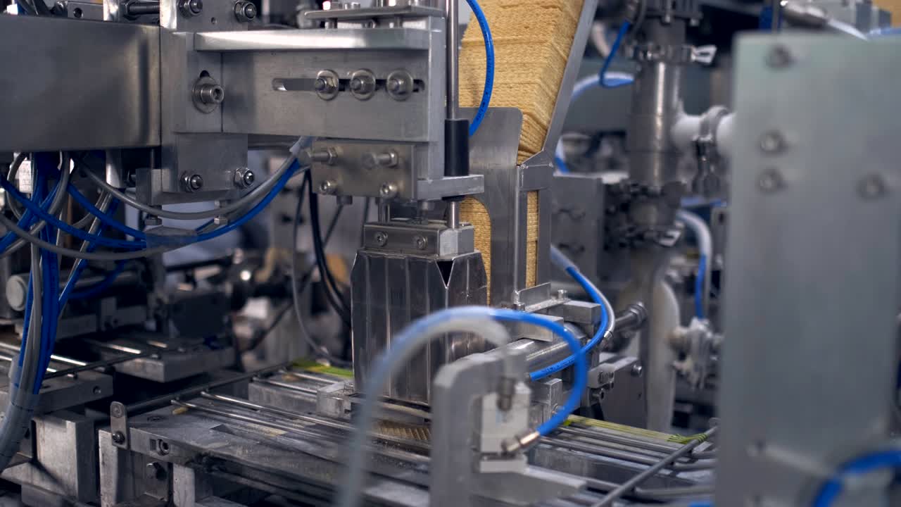 Ice Cream Production Line. Filling waffle cups with ice cream. ice cream factory vanilla chocolate fridge, packaging, waffle cups