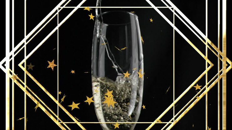 Animazione di stelle fluttuanti e una cornice dorata sopra un bicchiere di champagne su sfondo nero.