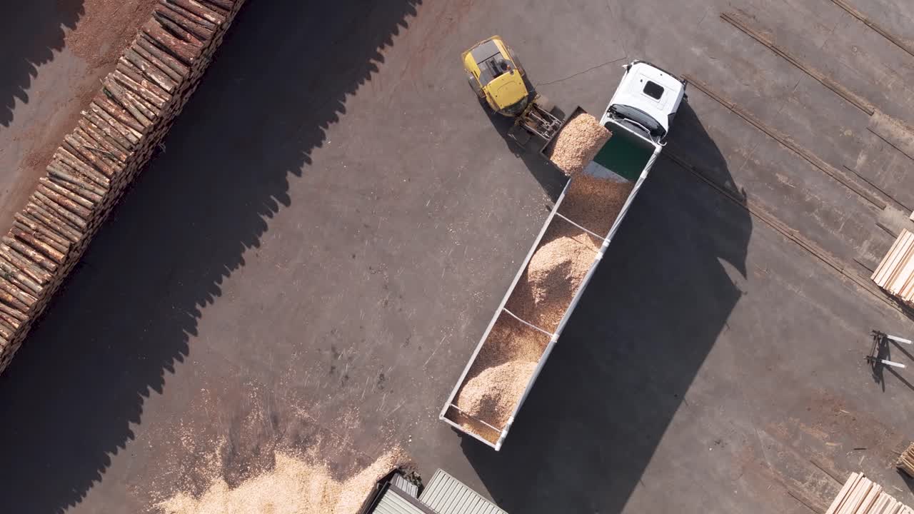 Payloader Loading Bulk Of Sawdust Into Trailer Truck At Wood Factory