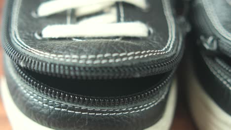 closeup of black leather shoes with zippers