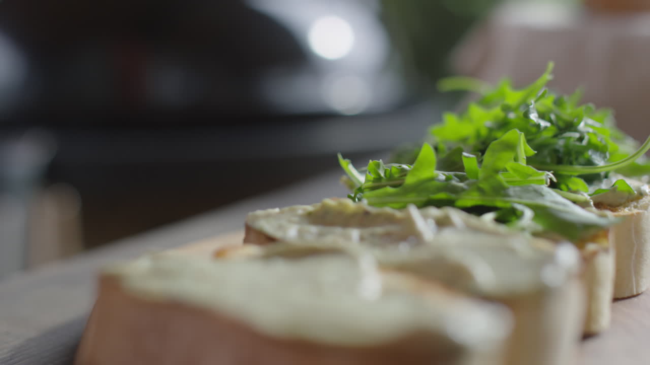 Preparing Bruschettas with Arugula Leaves
