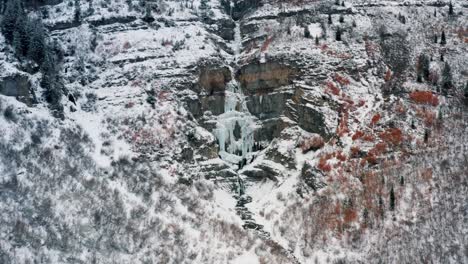 wide aerial drone view of the stunning frozen stewart falls waterfall near sundance ski resort in provo that requires a small hike