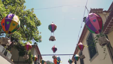 colorful hot air balloon decorations in a narrow town street