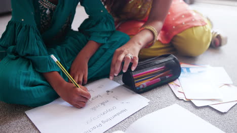 girl doing homework with mother