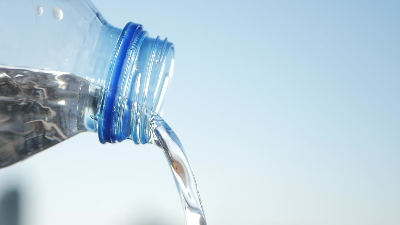 Water pouring from a plastic bottle