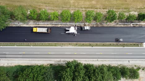 Asphalt-paver-at-work,-aerial-view